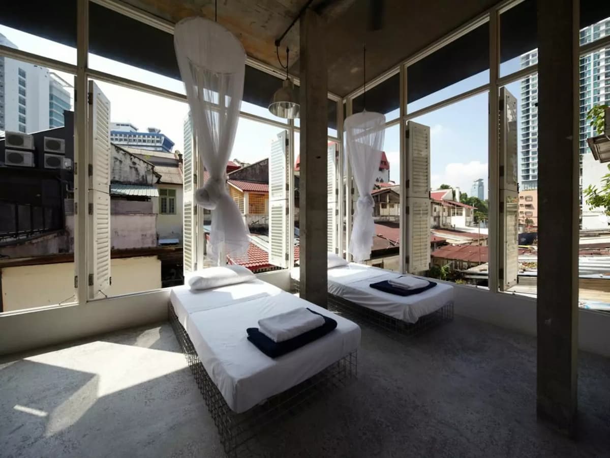 boutique hotel room in kuala lumpur with large windows and bed nets