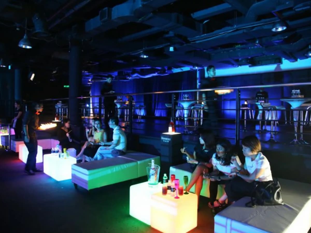 people enjoying nigh out at bar with unique lighting table