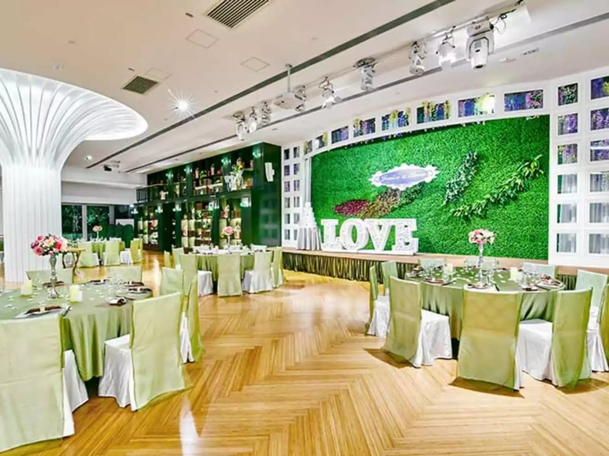 wedding party in the ballroom with garden decoration at the stage