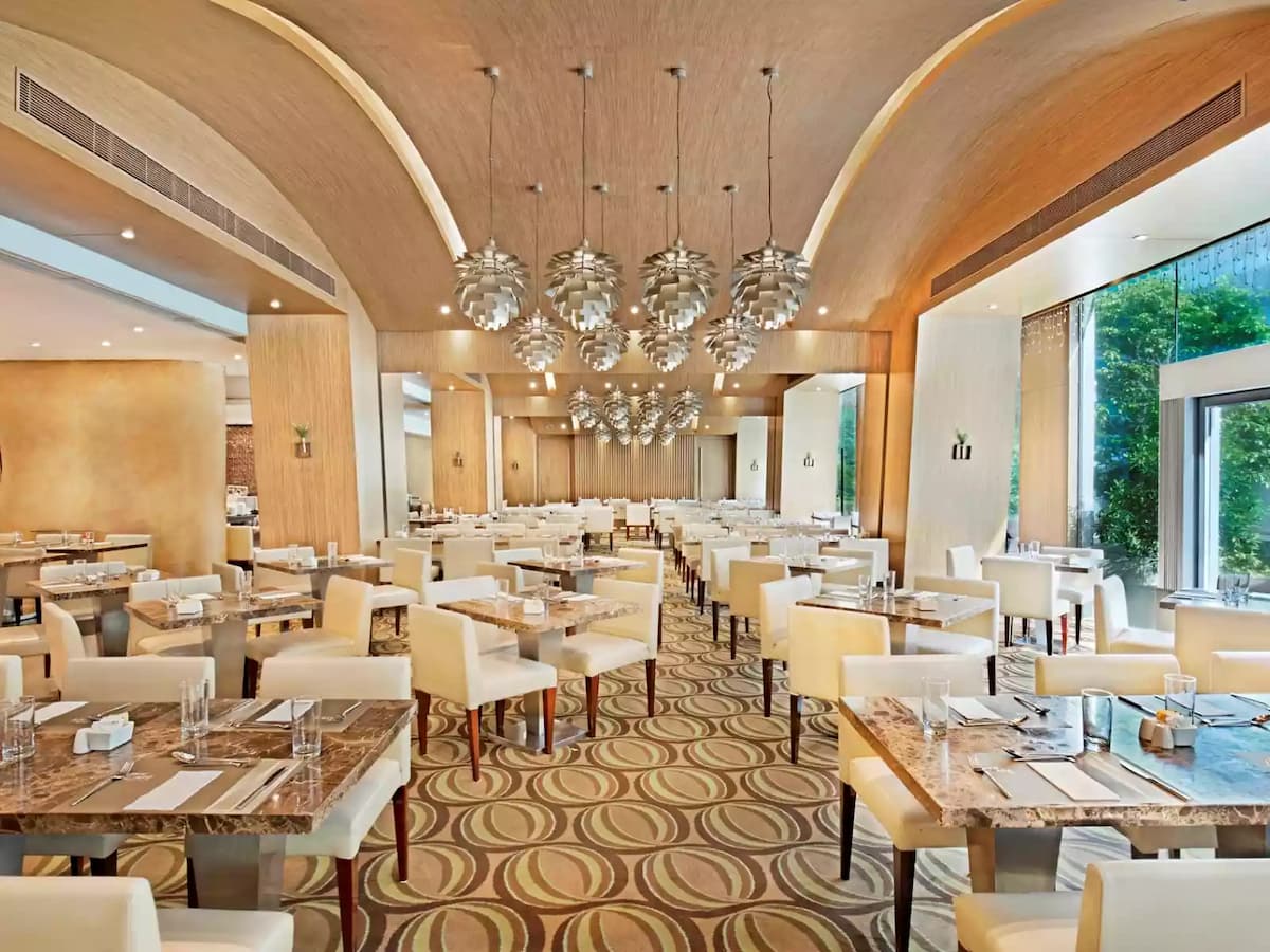 main dining area for corporate event decorated with lot of chandelier