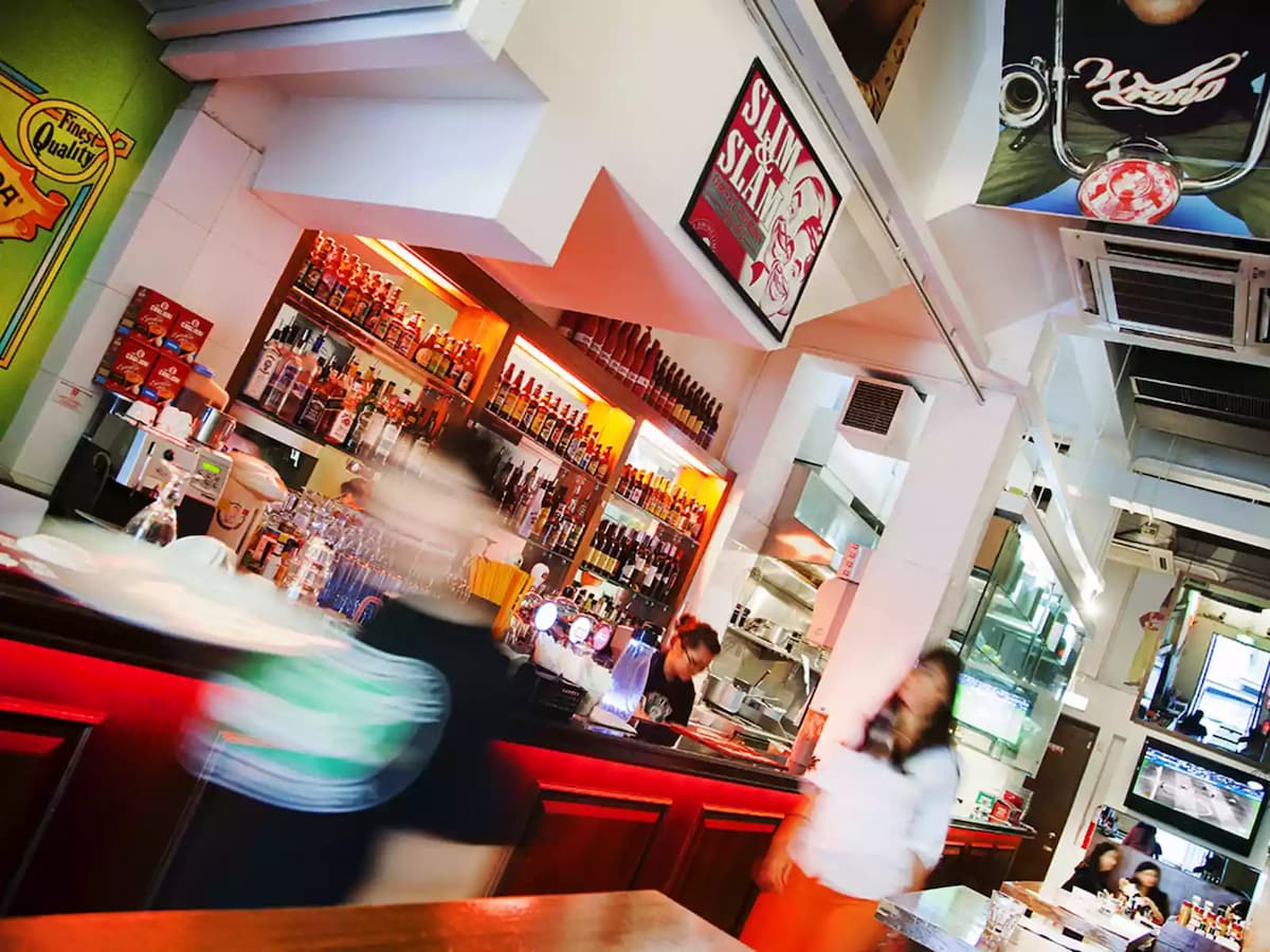 customers walking in front of bar