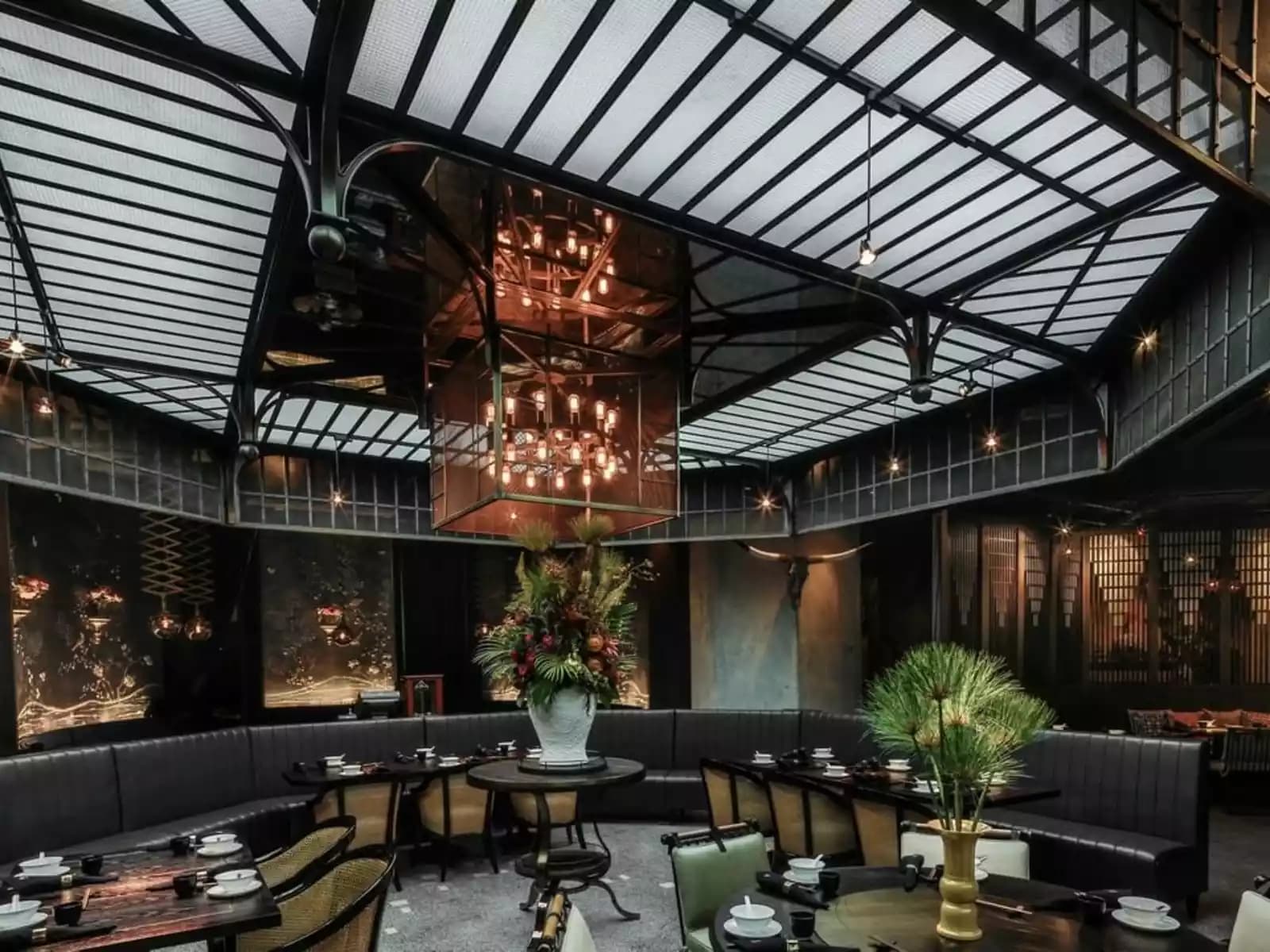 chandelier hanged on a transparent ceiling and flower centrepiece in the restaurant