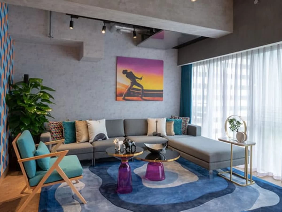lounge area with natural light and bohemian rhapsody painting on the wall