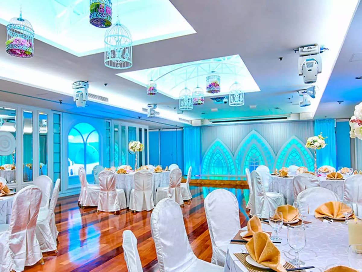blue themed of ballroom with round table setup and wooden floor