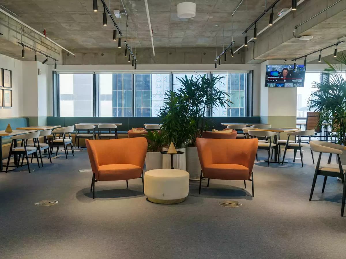 two orange sofa at the middle of the space for speaker