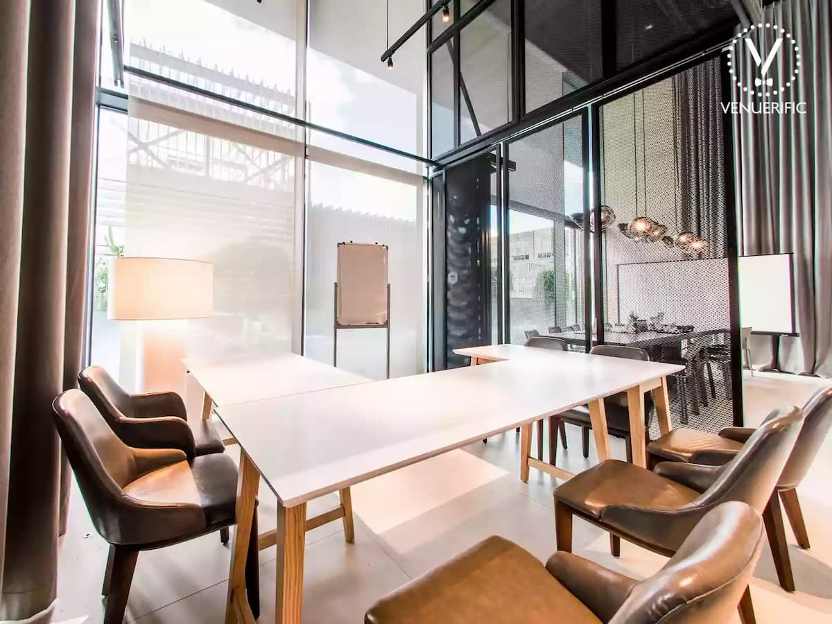 small meeting room with white board and big window with natural lighting for corporate meetings