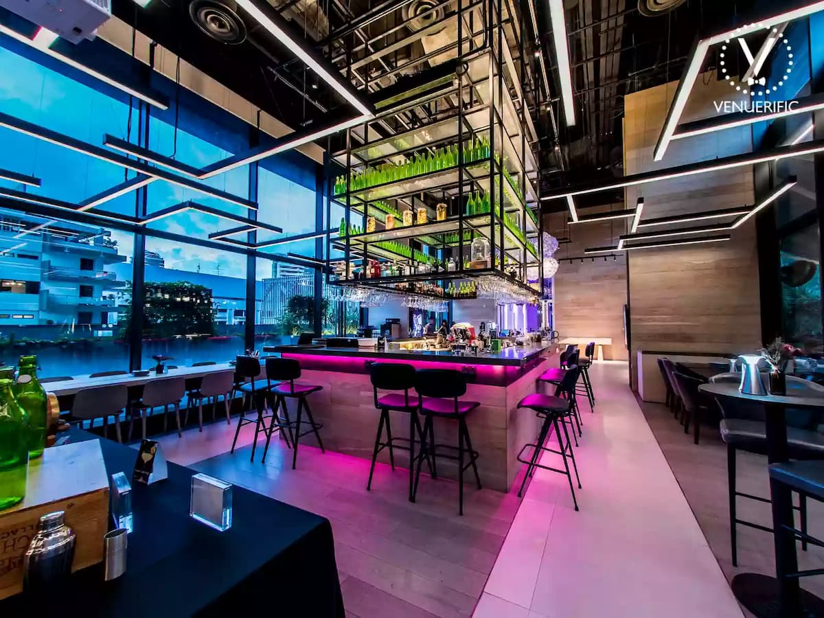 21st birthday party venue with middle bar seating area with purple lighting and natural view