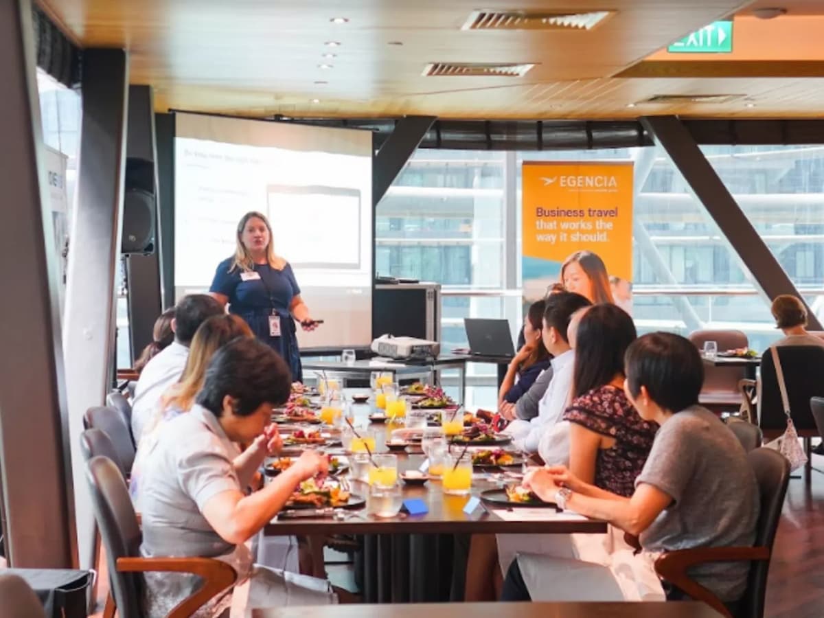people attending small seminar event venue in restaurant with a projector screen
