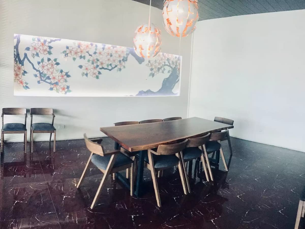 private dining room with long wooden table and painting decorations in makati restaurant