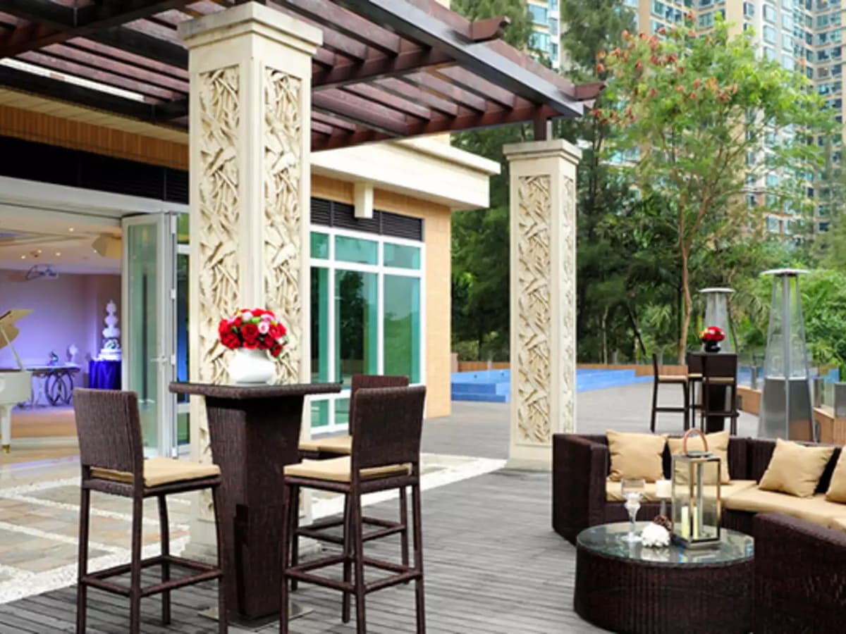 the outdoor area near the pool with high table and chair