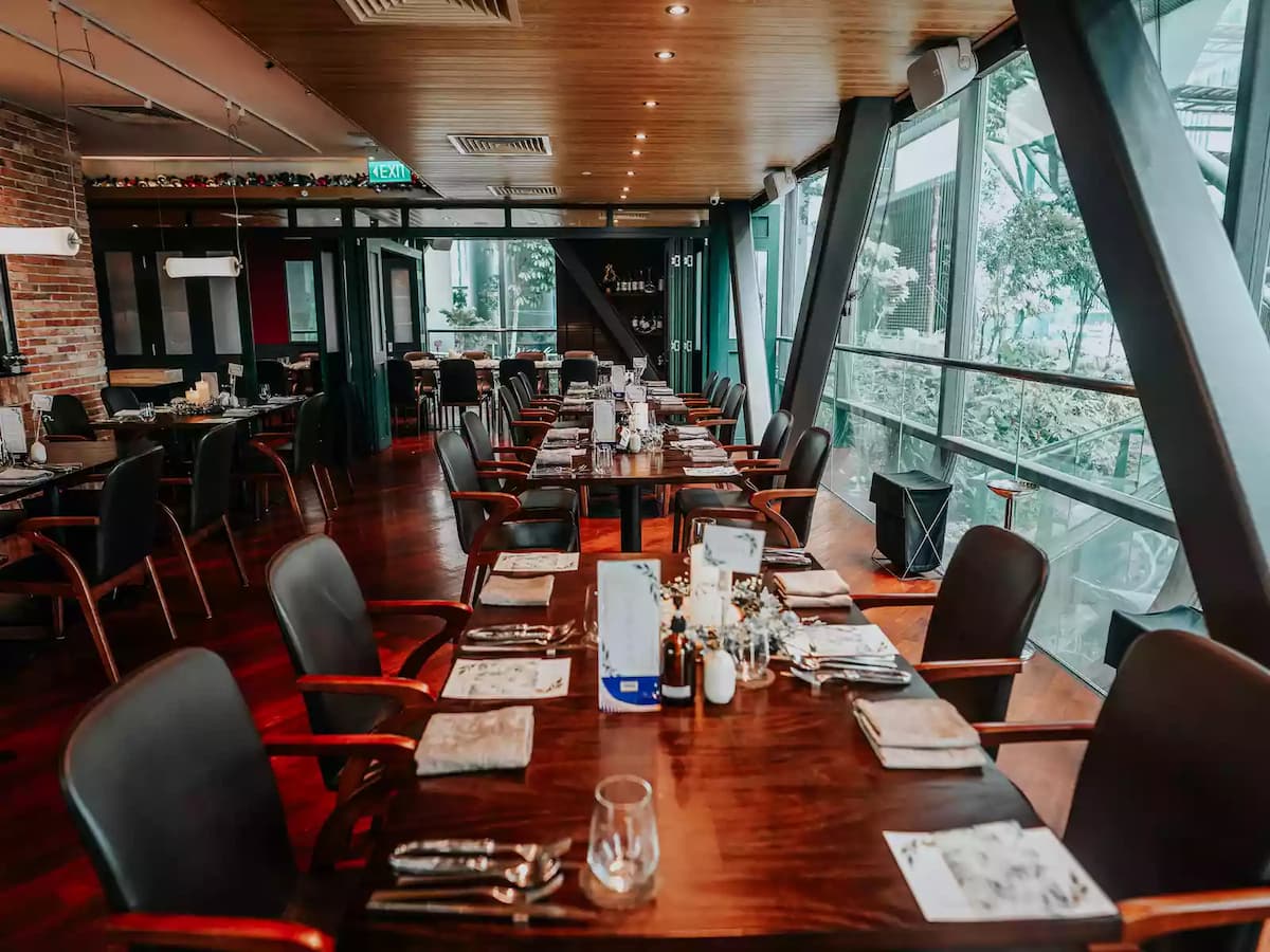 business luncheon event venue for rent in singapore restaurant with long dining table and large glass wall