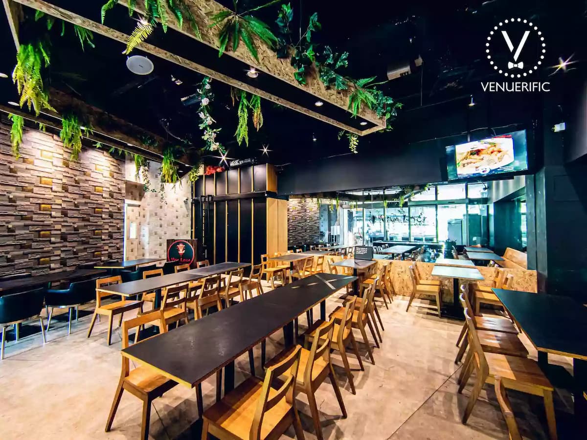 large workshop space in singapore with black interior and long table