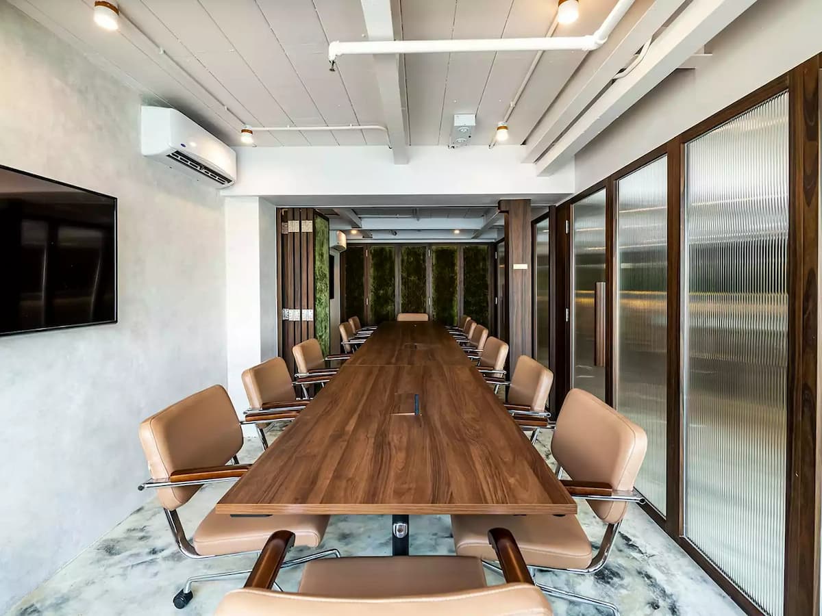 large rustic airconditioned conference room with leather chairs and tv for meeting venues for rent