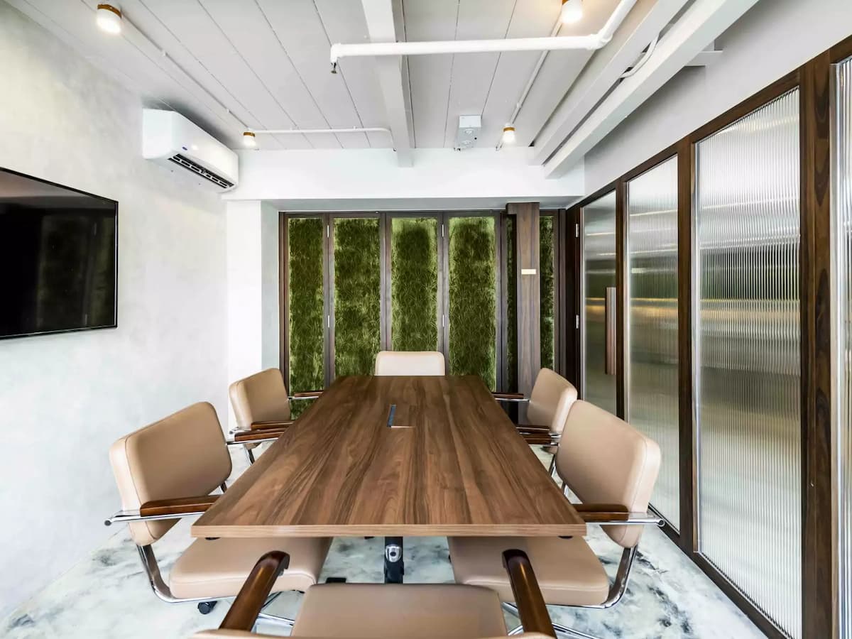 rustic medium airconditioned conference room with leather chairs and tv for meeting venues for rent