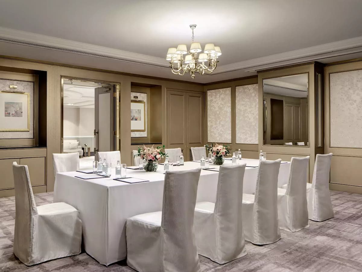 white tables and chairs in a luxurious private room