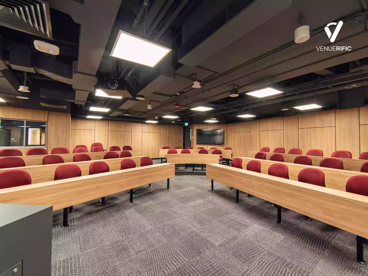 a room with red chairs and long wooden table