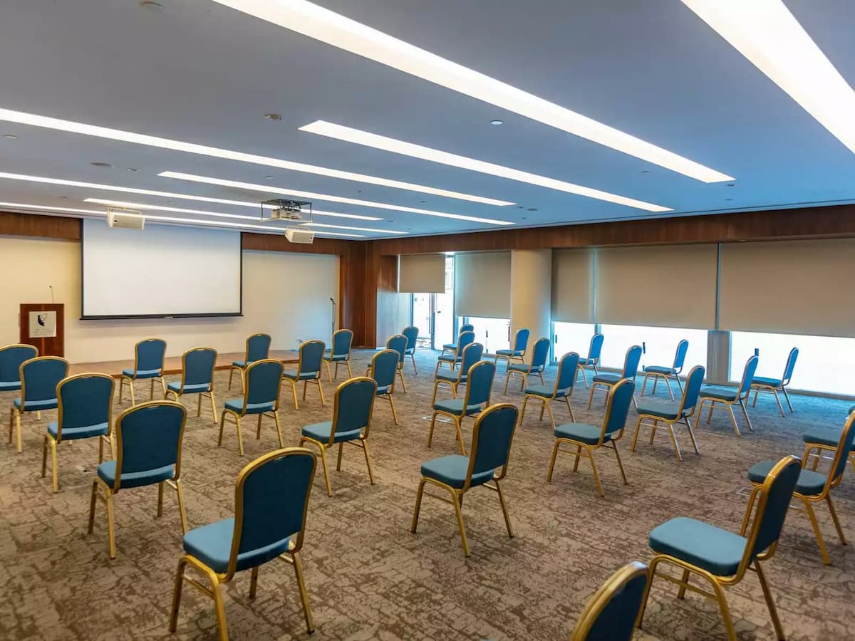 conference room with projector screen and blue chairs