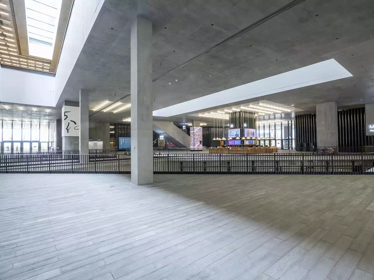 Wooden planks as floor in long grey spacious area