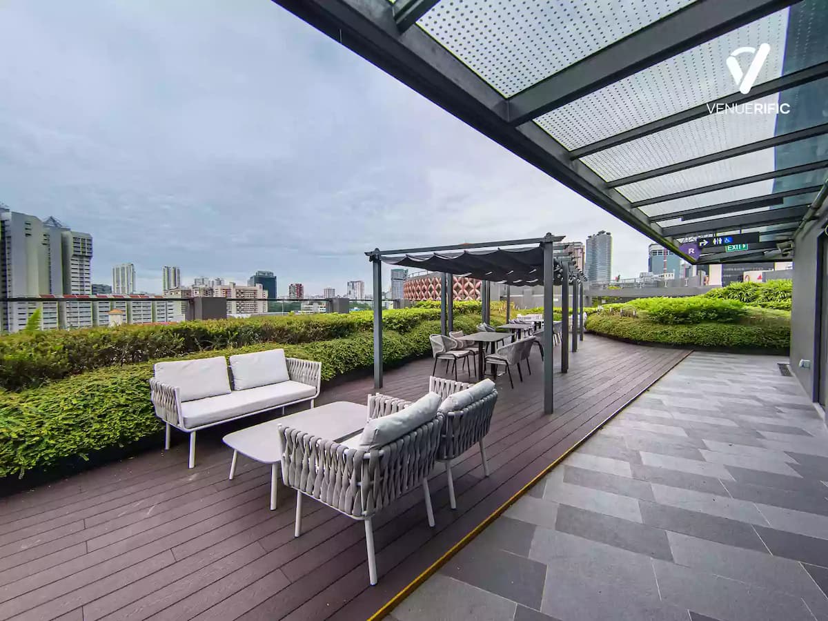 Outdoor patio with brown wooden floorings and white sofas