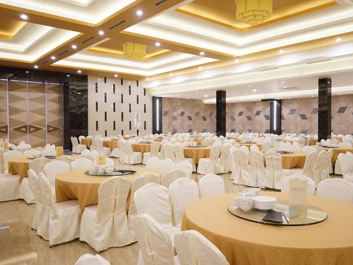 White chairs around gold round tables