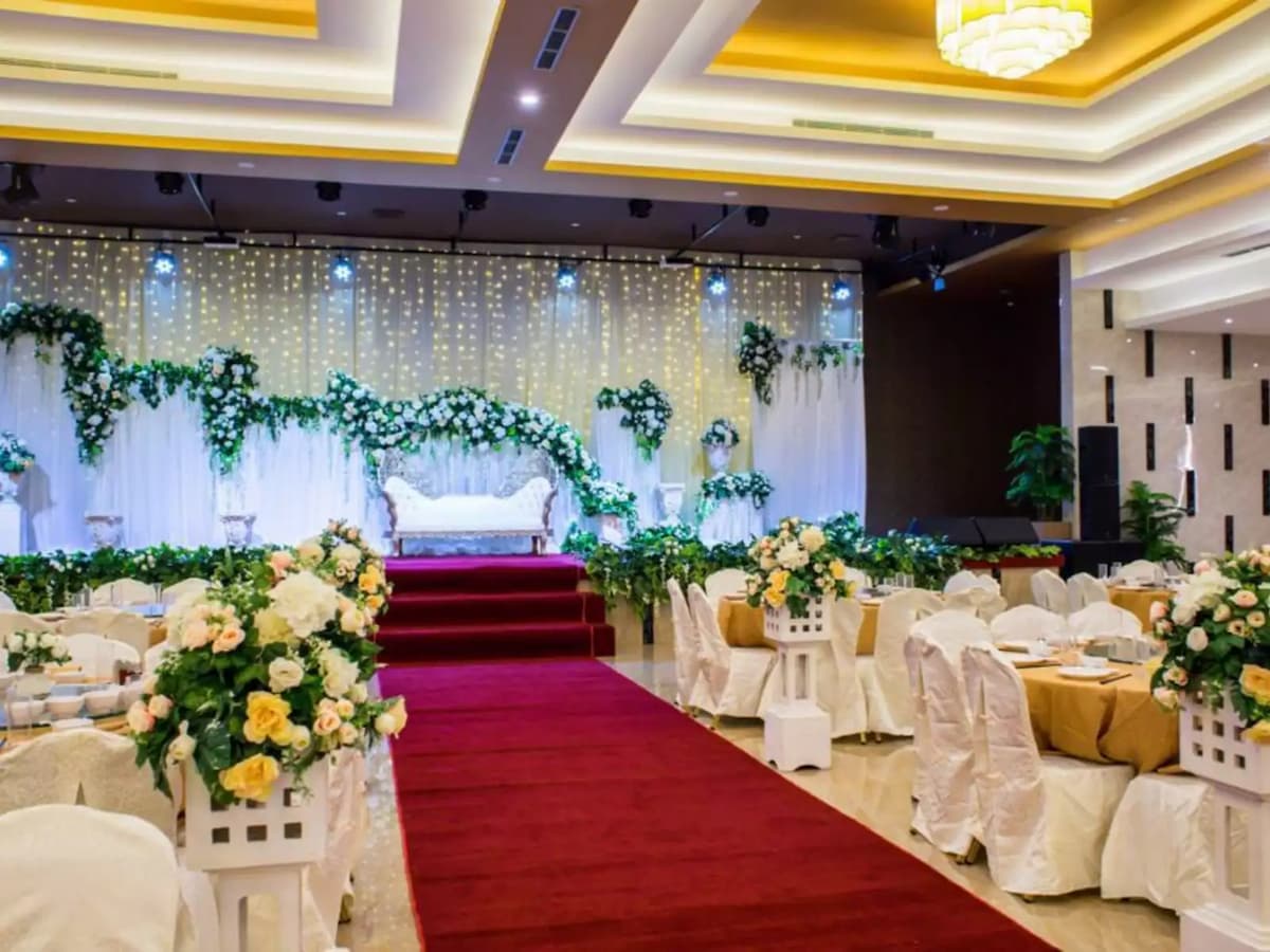 Red carpet leading to white sofa on stage