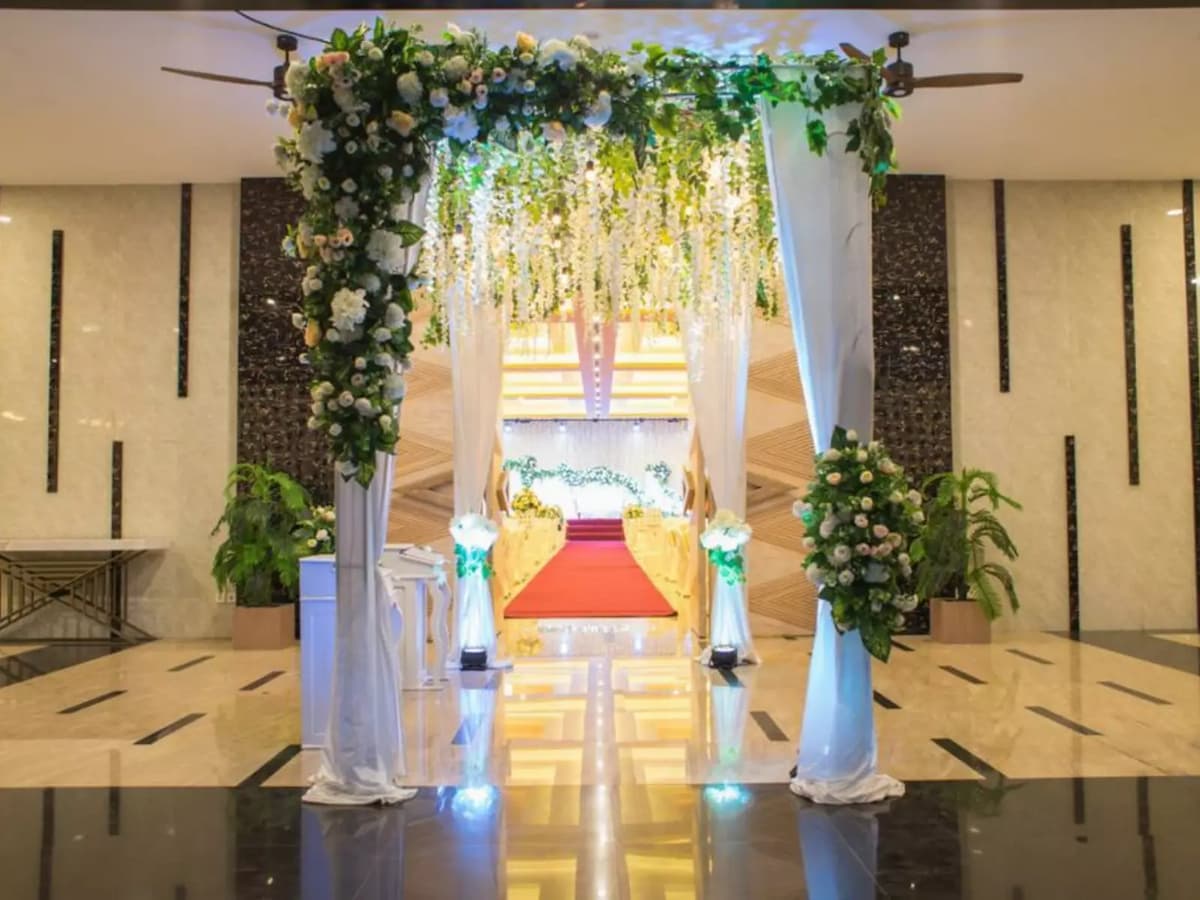 Lush green flowers on arch leading to grand ballroom