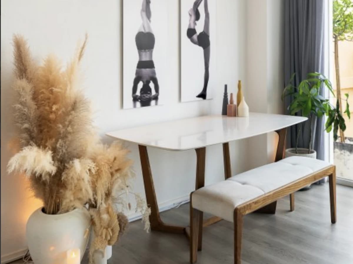 White marble table facing a wall with yoga poses