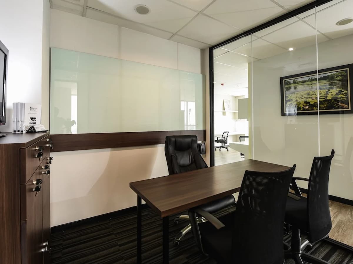small office meeting venue with desk and chairs and whiteboard and cabinets