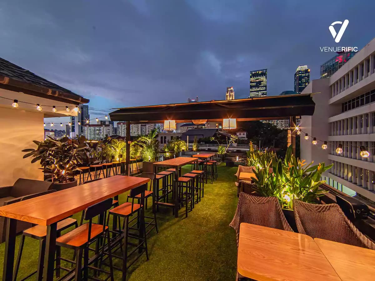 rooftop birthday party venue for rent with fairy lights and astro turf and wooden furniture