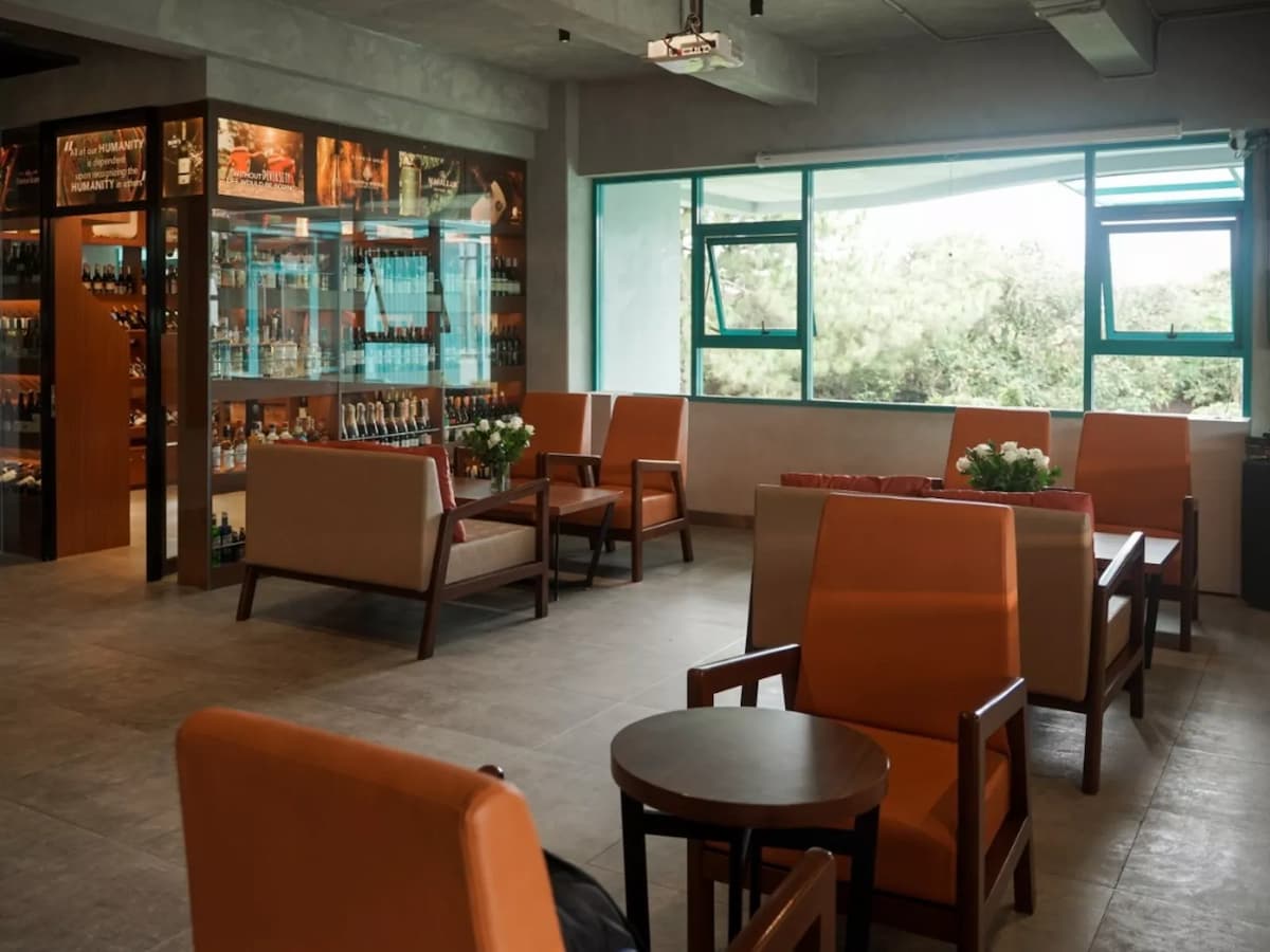 event space for rent in indonesia with orange chairs and alcohol display