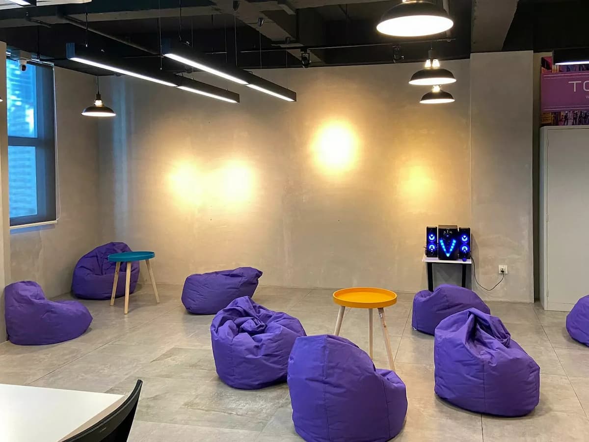 team building event venue in malaysia with purple bean bags all around industrial inspired room