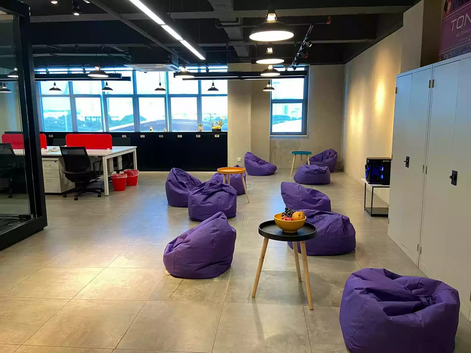 coworking space event venue with purple bean bags and work desks with natural light piercing through the office