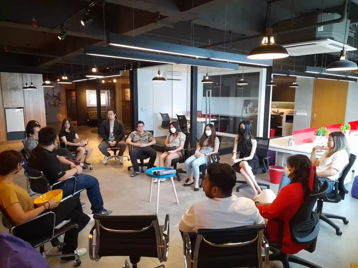 workshop event venue with large open space with coworker discussing around in a circle