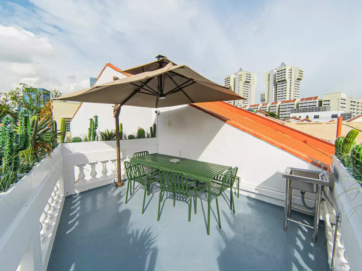 barbecue party event venue with rooftop terrace with green patio dining set and steel sink