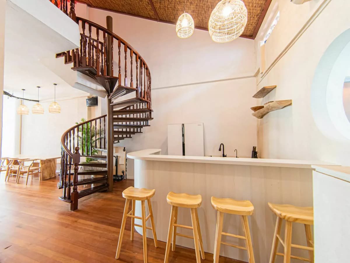 offsite meeting event venue with kitchenette with bar and spiral staircase leading up to loft