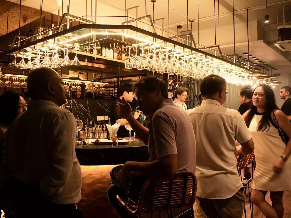 people standing by the bar