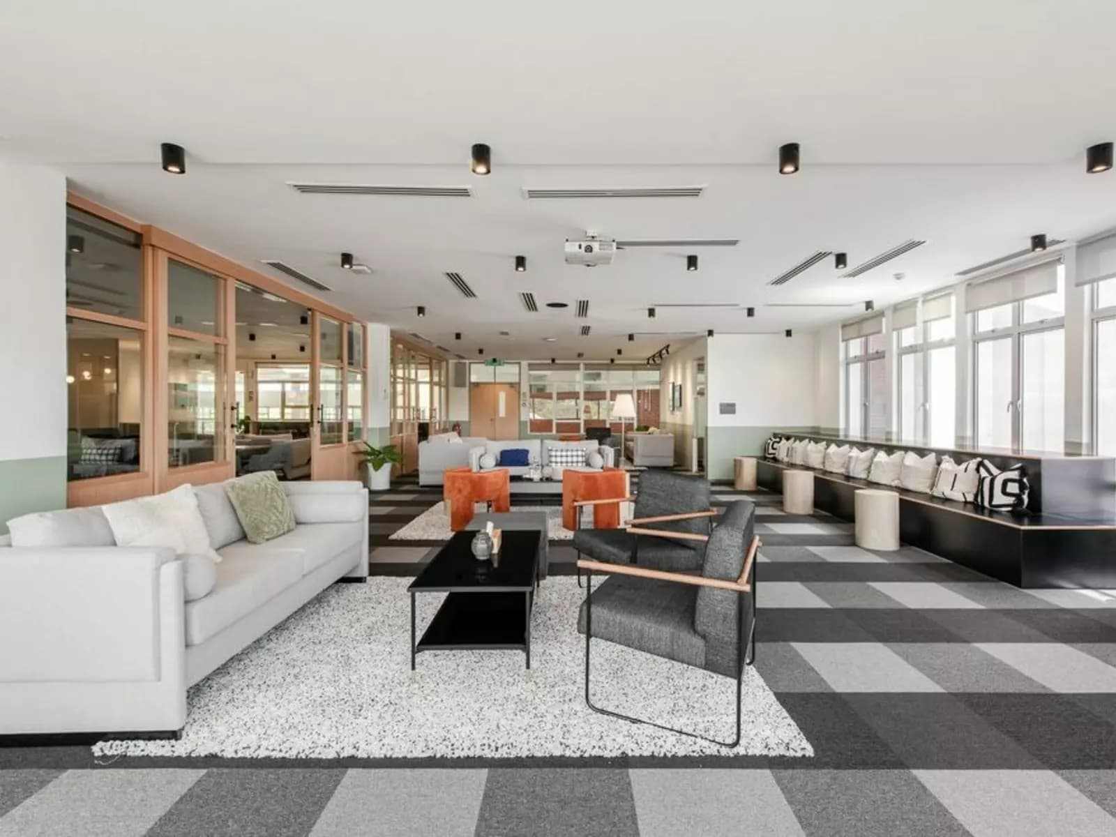 big room with natural lighting and carpeted chairs, floors, and sofas