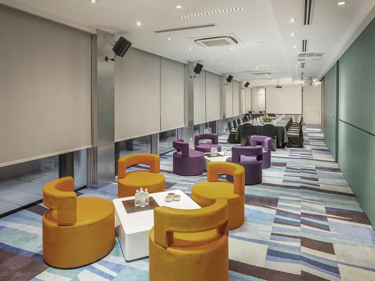 plush sofa chairs and long meeting table with projector