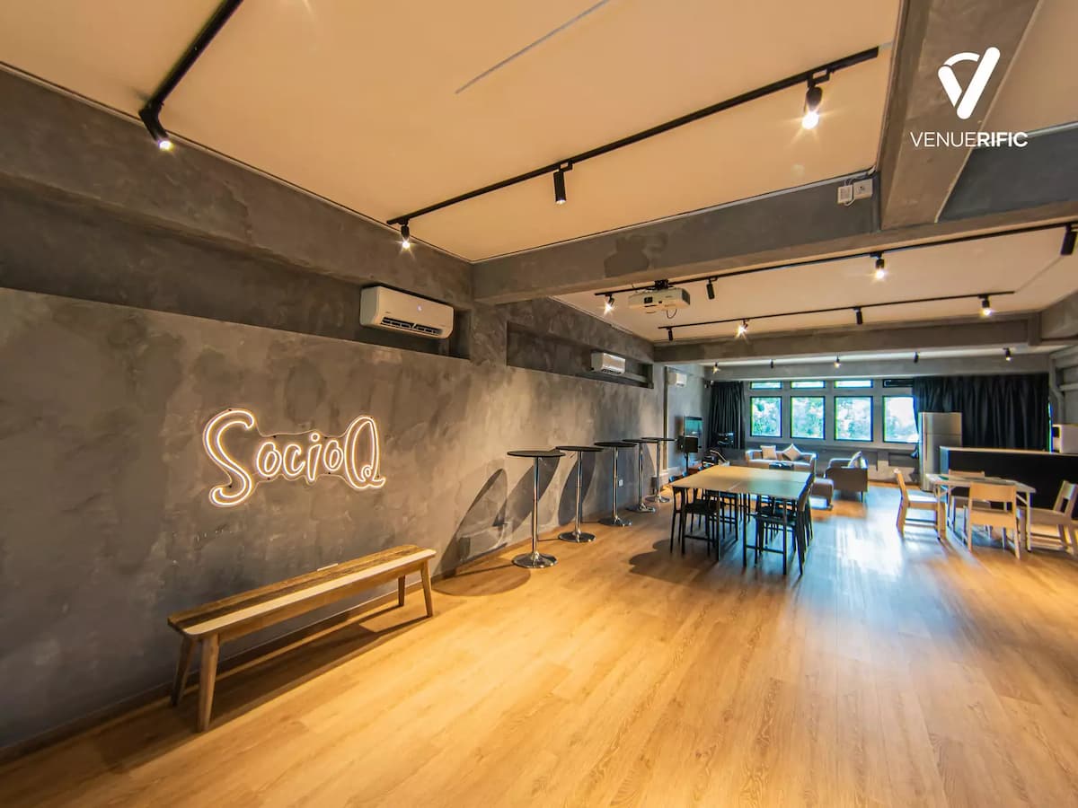 "socio q" logo in neon lights in industrial event space