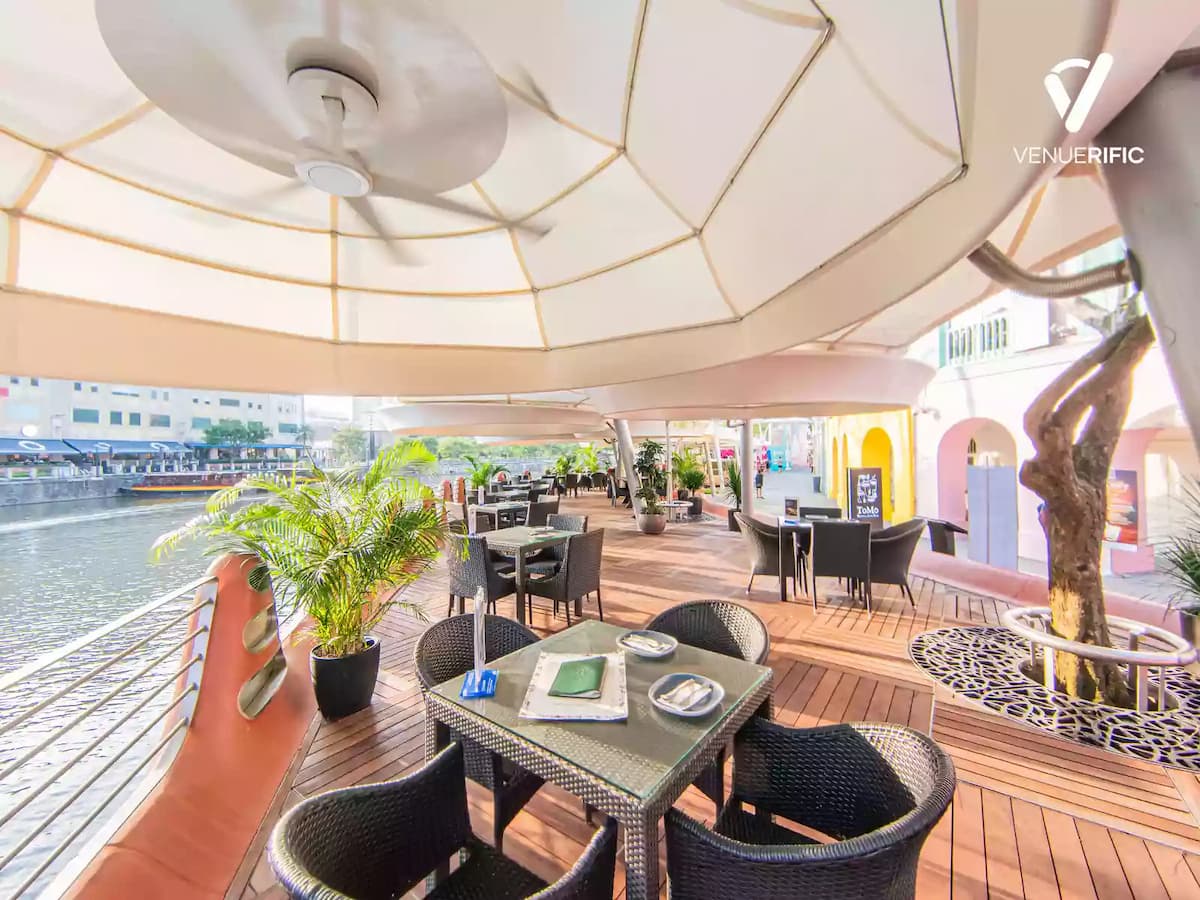 side view of dining area in front of river