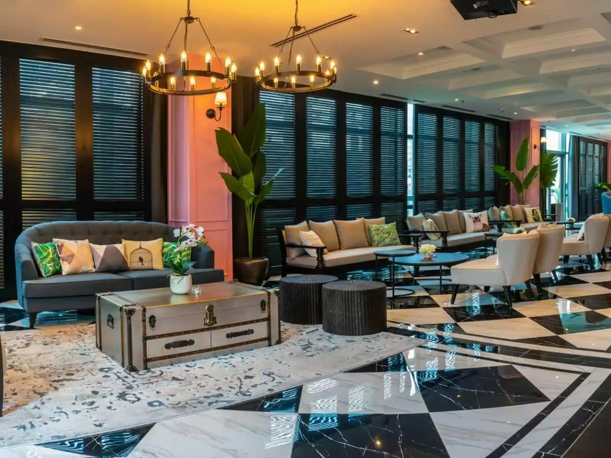 chandeliers above sofa seating and marble checkered floor at urban loft space event venue in kl eco city kuala lumpur