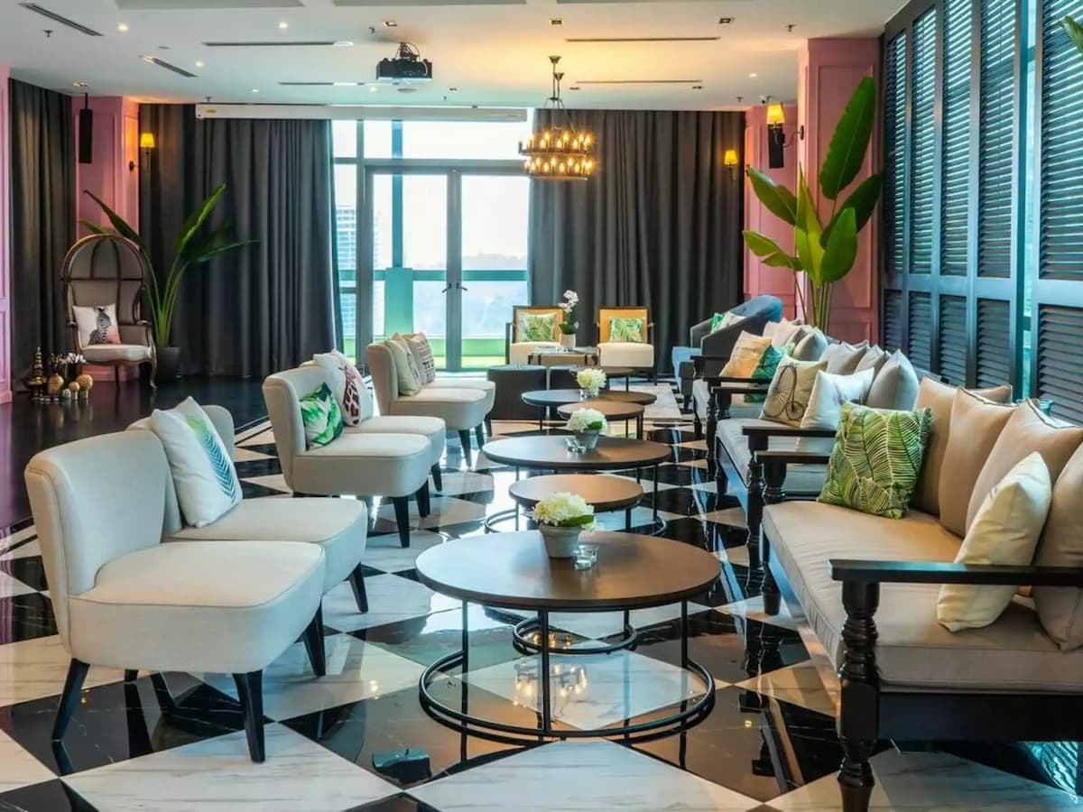 round coffee tables and lounge chairs arranged for a cocktail reception at urban loft space event space in kl eco city