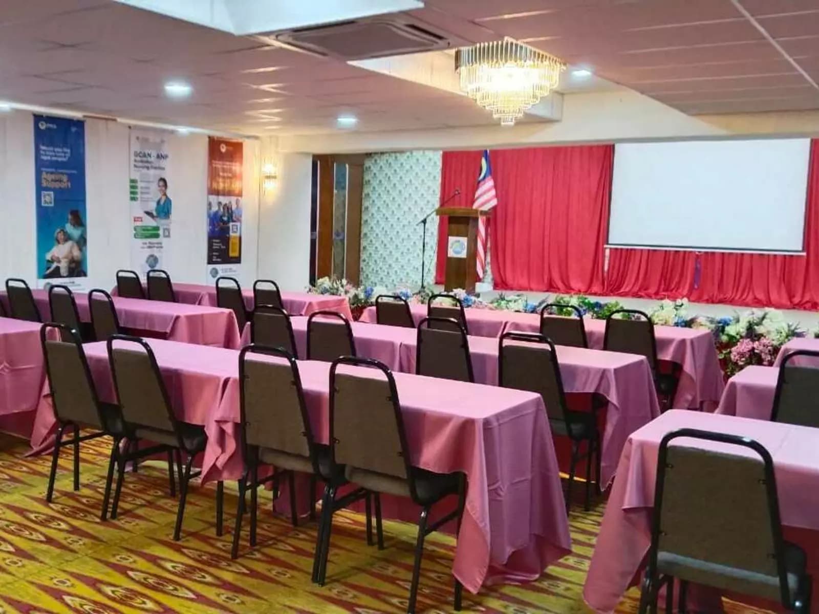 group of chairs facing a stage with projector screen