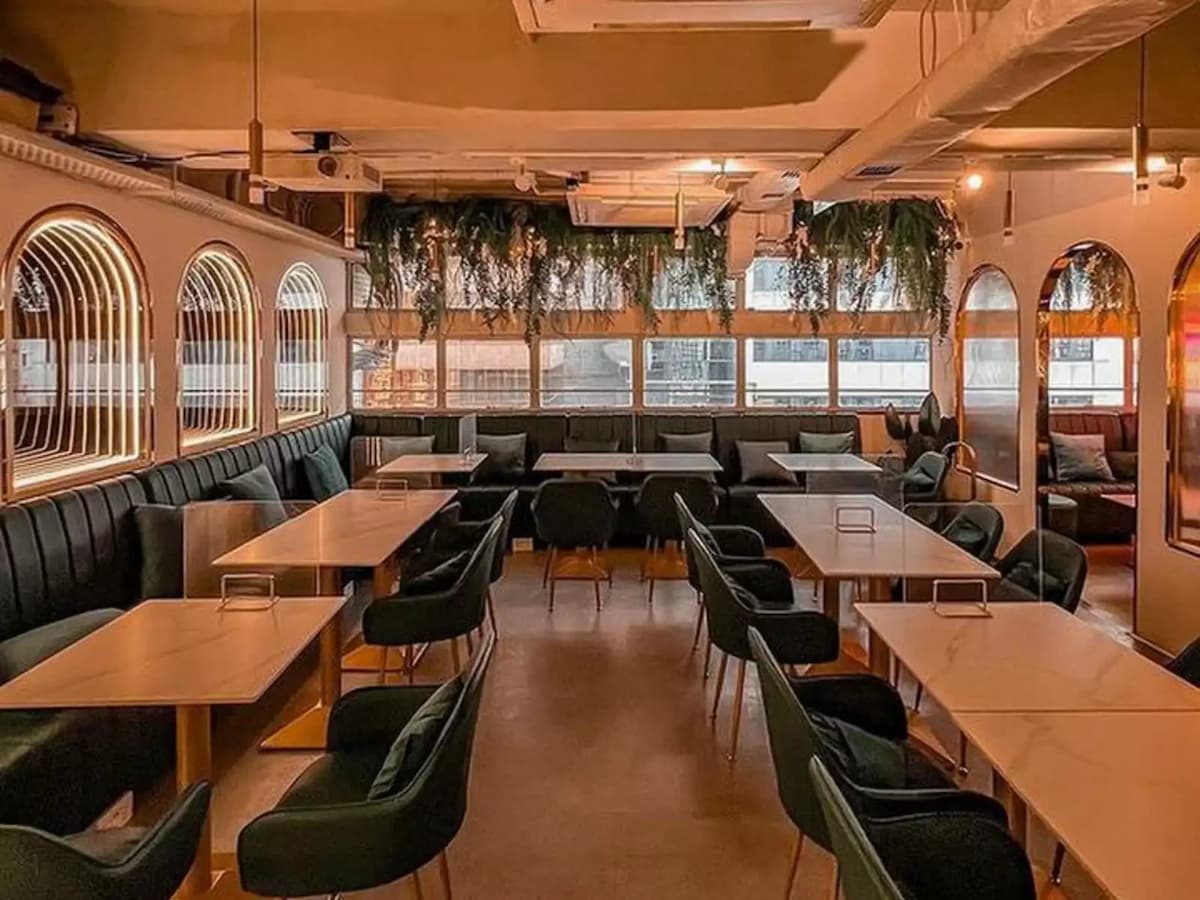 cafe and restaurant with leather couches and chairs and white tables