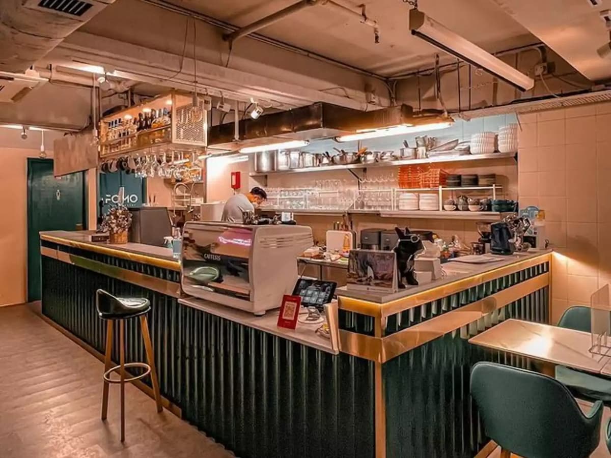 coffee bar counter with espresso machine and pieces of glassware