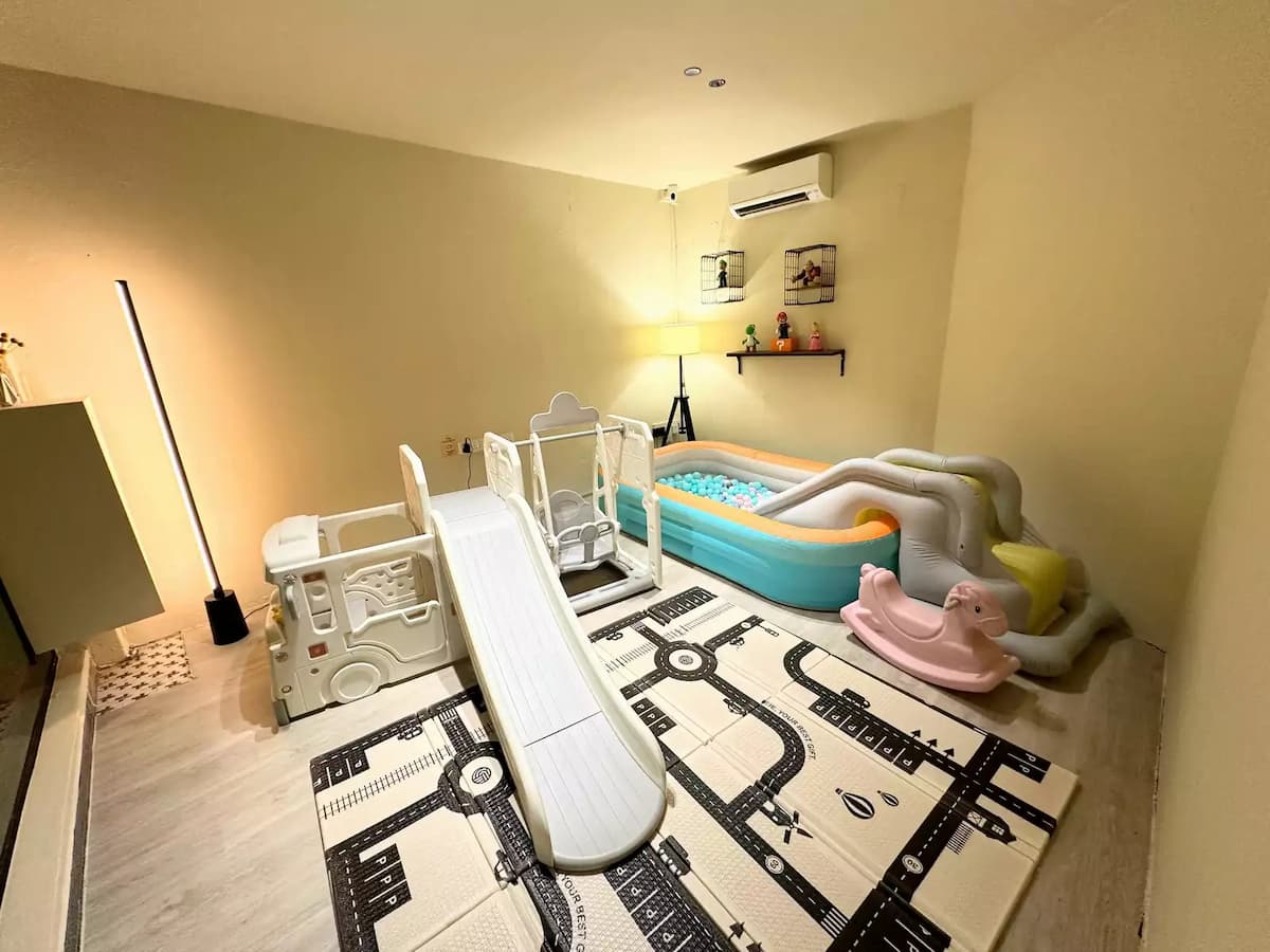 kids play room with slide and ball pit