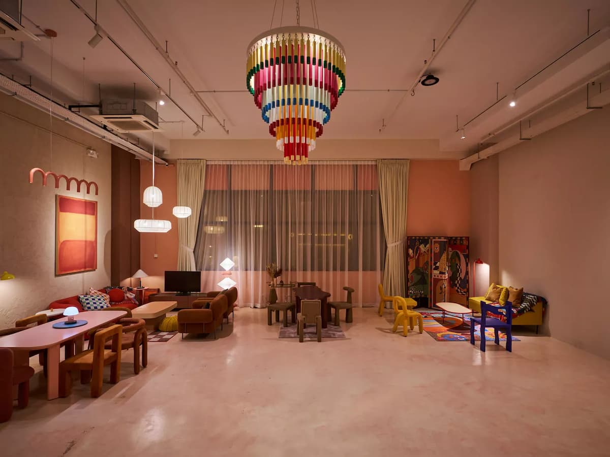 modern retro event space with dining tables and colourful chandelier at creative studio in kallang singapore