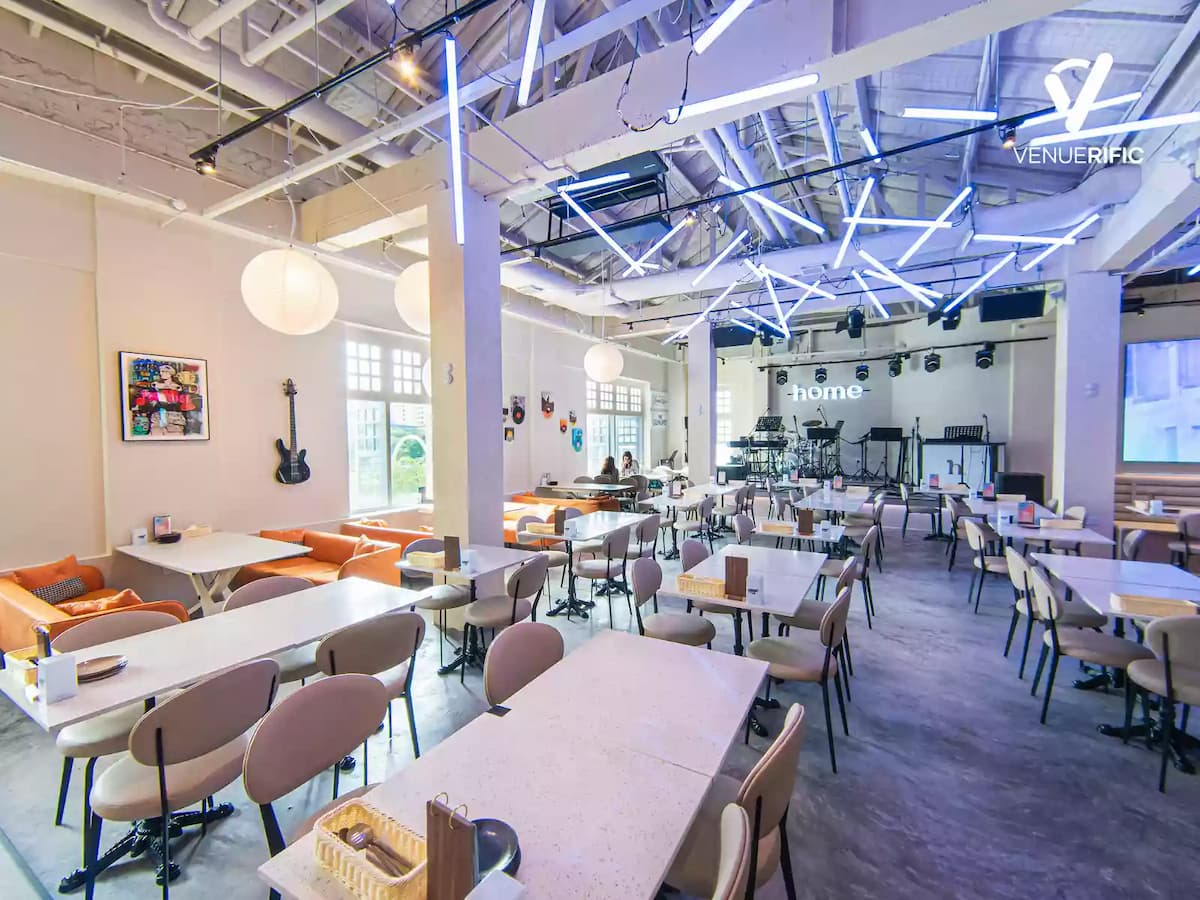 large dining hall with neon lighting and a stage