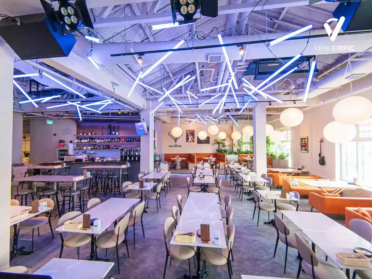 bar, lounges, and dining areas in event hall with neon lights