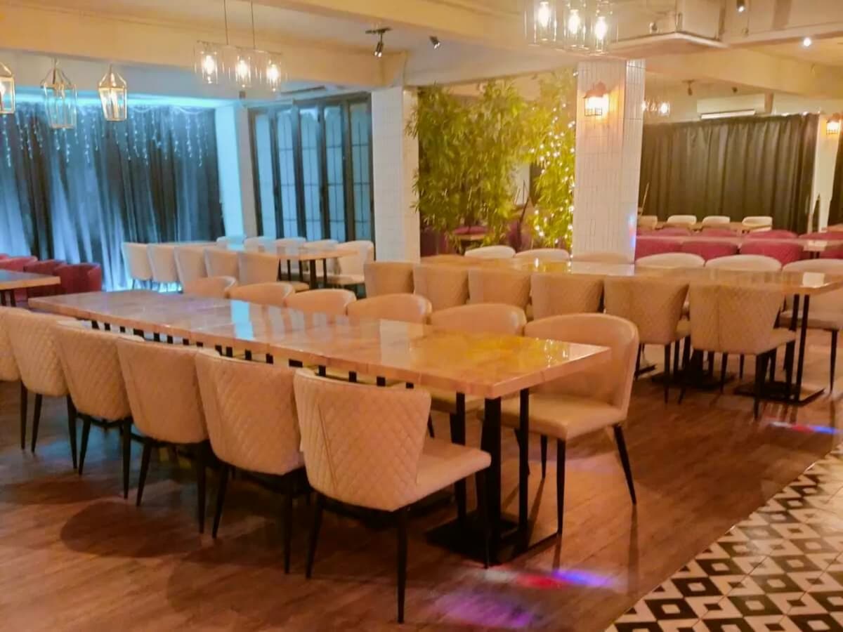 event space with marble tables and romantic decor